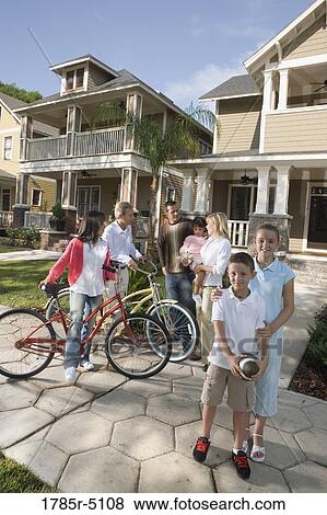 Family with young children conversing with neighbors in front of house View Large Photo Image Stock Photo - Family with young children conversing with neighbors in front of house. Fotosearch