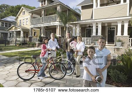 Family with young children standing with neighbors in front of house View Large Photo Image Stock Photo - Family with young children standing with neighbors in front of house. Fotosearch