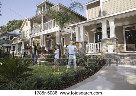 Father and children playing catch in front yard View Large Photo Image Stock Photograph - Father and children playing catch in front yard. Fotosearch