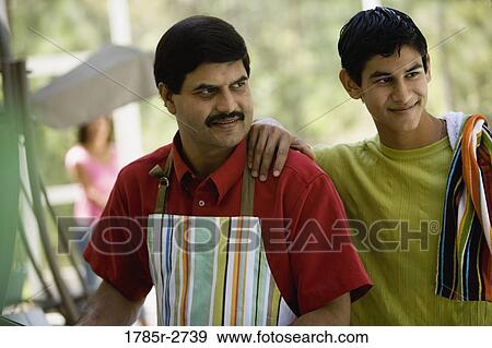 Father and son standing together View Large Photo Image Stock Photo - Father and son standing together. Fotosearch