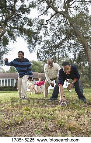Father and sons playing football in backyard View Large Photo Image Stock Photography - Father and sons playing football in backyard. Fotosearch