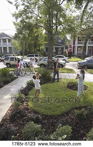 Father playing catch with children in front yard View Large Photo Image Stock Image - Father playing catch with children in front yard. Fotosearch