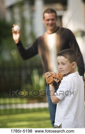 Stock Photo - Father throwing a baseball to his son. Fotosearch