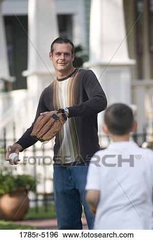 Stock Photograph - Father throwing a baseball to his son. Fotosearch
