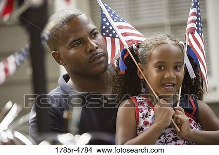 Father with daughter waving US flag View Large Photo Image Picture - Father with daughter waving US flag. Fotosearch
