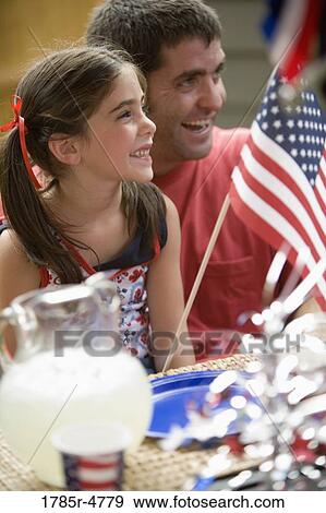 Stock Photo - Father with daughter waving US flag. Fotosearch
