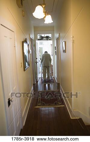 Feeble senior man slowly going down hallway with walker View Large Photo Image Stock Photo - Feeble senior man slowly going down hallway with walker. Fotosearch