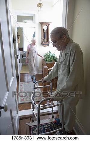 Feeble senior man standing with walker in doorway View Large Photo Image Stock Image - Feeble senior man standing with walker in doorway. Fotosearch