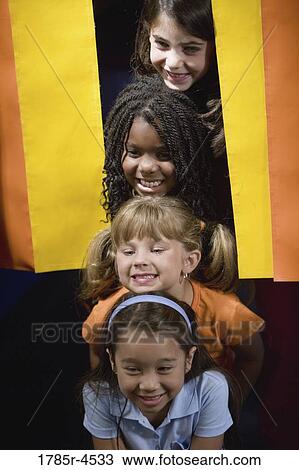 Four girls peeking out from behind a curtain View Large Photo Image Stock Image - Four girls peeking out from behind a curtain. Fotosearch