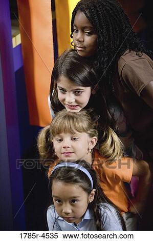 Stock Photography - Four girls stacked in a row. Fotosearch