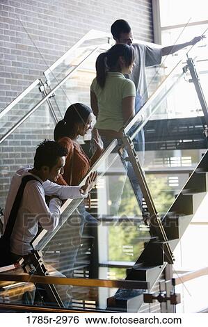 Stock Photograph - Four students climbing stairs. Fotosearch