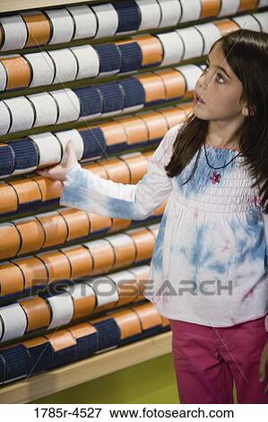 Girl (5-6) pointing to a colorful art project View Large Photo Image Stock Photo - Girl (5-6) pointing to a colorful art project. Fotosearch