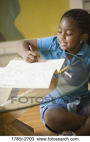 Girl coloring a book View Large Photo Image Stock Image - Girl coloring a book. Fotosearch