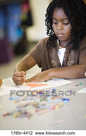 Girl drawing with crayons in an art class View Large Photo Image Stock Image - Girl drawing with crayons in an art class. Fotosearch