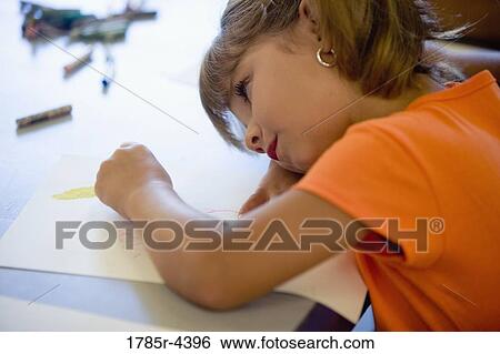 Girl drawing with crayons View Large Photo Image Stock Photograph - Girl drawing with crayons. Fotosearch
