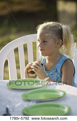 Girl eating a burger View Large Photo Image Stock Image - Girl eating a burger. Fotosearch