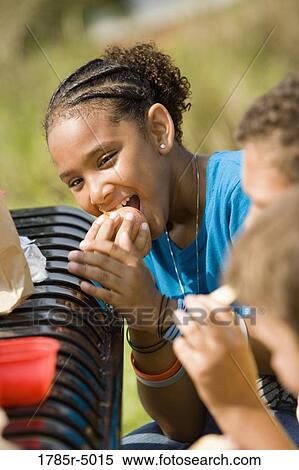 Girl eating an apple View Large Photo Image Stock Photography - Girl eating an apple. Fotosearch
