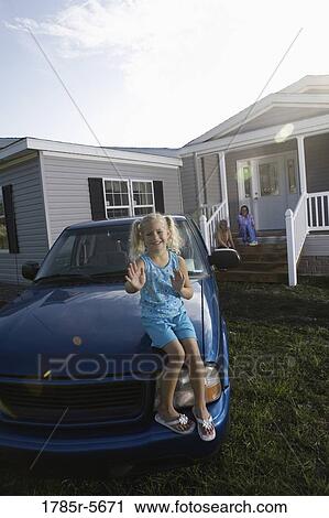 Girl sitting on hood of old truck playing patty-cake View Large Photo Image Stock Image - Girl sitting on hood of old truck playing patty-cake. Fotosearch