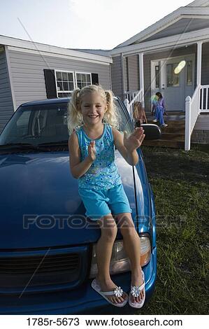 Girl sitting on hood of old truck playing patty-cake by herself View Large Photo Image Stock Image - Girl sitting on hood of old truck playing patty-cake by herself. Fotosearch