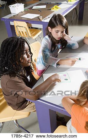 Girls drawing in art class View Large Photo Image Stock Photo - Girls drawing in art class. Fotosearch