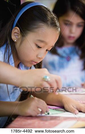Girls drawing with color crayons View Large Photo Image Stock Image - Girls drawing with color crayons. Fotosearch