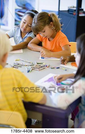 Girls drawing with crayons in an art class View Large Photo Image Stock Photo - Girls drawing with crayons in an art class. Fotosearch