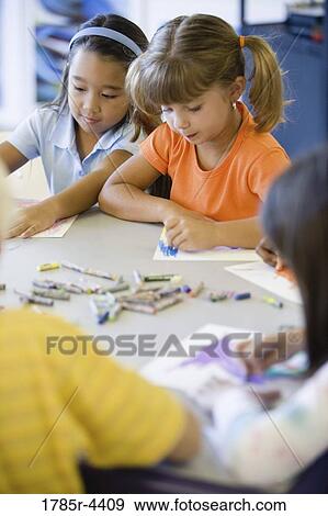 Girls drawing with crayons in an art class View Large Photo Image Stock Photo - Girls drawing with crayons in an art class. Fotosearch