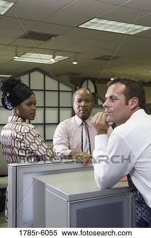 Group of co-workers standing around a cubicle View Large Photo Image Stock Photography - Group of co-workers standing around a cubicle. Fotosearch