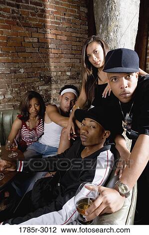 Group of young men and women in hip-hop fashion partying View Large Photo Image Stock Image - Group of young men and women in hip-hop fashion partying. Fotosearch