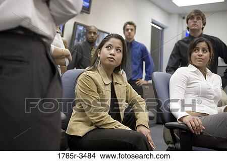 Picture - Group of young office workers together in meeting. Fotosearch