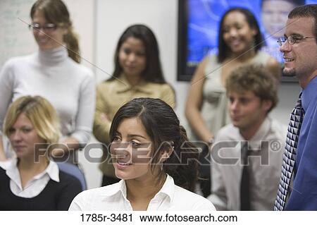 Group of young office workers together in meeting View Large Photo Image Stock Image - Group of young office workers together in meeting. Fotosearch