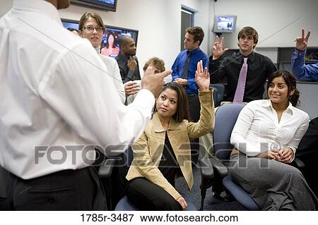 Stock Photo - Group of young office workers together in meeting. Fotosearch