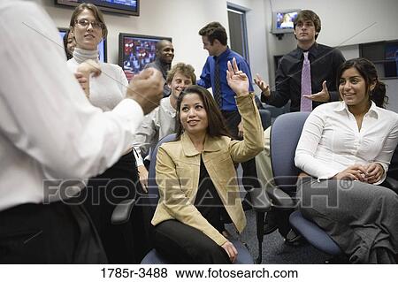 Group of young office workers together in meeting View Large Photo Image Stock Photo - Group of young office workers together in meeting. Fotosearch