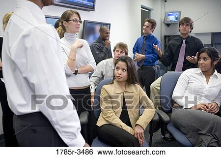 Group of young office workers together in meeting View Large Photo Image Stock Photograph - Group of young office workers together in meeting. Fotosearch