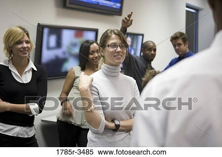 Group of young office workers together in meeting View Large Photo Image Stock Photography - Group of young office workers together in meeting. Fotosearch