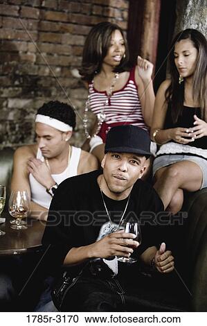 Group of young people partying at a nightclub View Large Photo Image Stock Image - Group of young people partying at a nightclub. Fotosearch