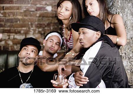 Stock Photo - Group of young people partying at a nightclub. Fotosearch
