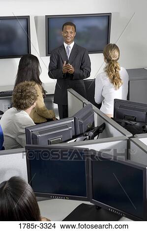 Picture - Group of young workers in office having meeting. Fotosearch