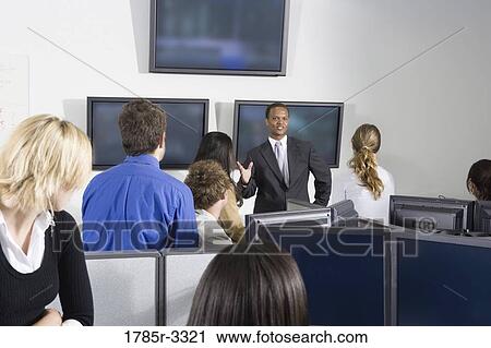 Group of young workers in office having meeting View Large Photo Image Stock Image - Group of young workers in office having meeting. Fotosearch