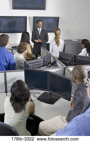 Group of young workers in office having meeting View Large Photo Image Stock Image - Group of young workers in office having meeting. Fotosearch