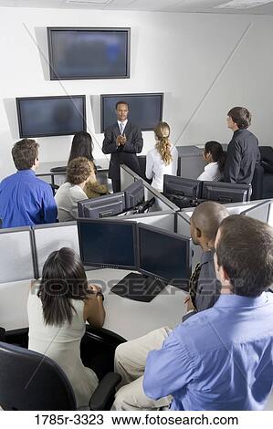 Group of young workers in office having meeting View Large Photo Image Stock Image - Group of young workers in office having meeting. Fotosearch