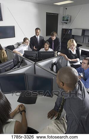 Group of young workers in office having meeting View Large Photo Image Stock Photograph - Group of young workers in office having meeting. Fotosearch