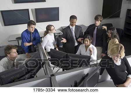 Group of young workers in office working on computers View Large Photo Image Picture - Group of young workers in office working on computers. Fotosearch