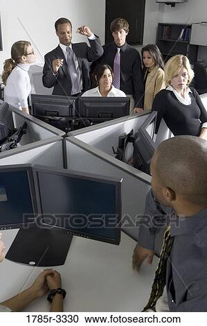 Group of young workers in office working on computers View Large Photo Image Stock Image - Group of young workers in office working on computers. Fotosearch