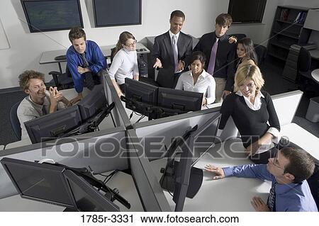 Group of young workers in office working on computers View Large Photo Image Stock Image - Group of young workers in office working on computers. Fotosearch
