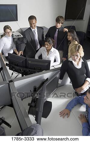 Group of young workers in office working on computers View Large Photo Image Stock Image - Group of young workers in office working on computers. Fotosearch