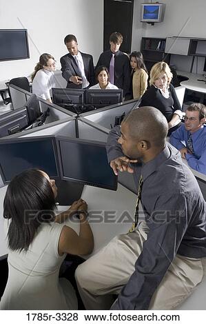 Group of young workers in office working on computers View Large Photo Image Stock Photo - Group of young workers in office working on computers. Fotosearch