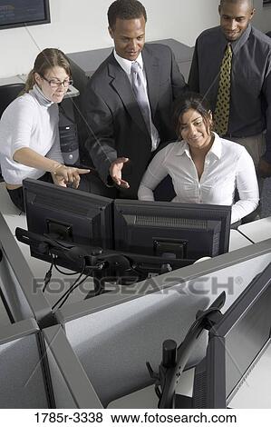Group of young workers in office working on computers View Large Photo Image Stock Photo - Group of young workers in office working on computers. Fotosearch