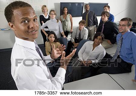 Group of young workers in office gathered for a meeting View Large Photo Image Stock Photo - Group of young workers in office gathered for a meeting. Fotosearch