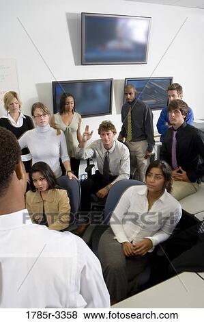 Group of young workers in office gathered for a meeting View Large Photo Image Stock Photo - Group of young workers in office gathered for a meeting. Fotosearch